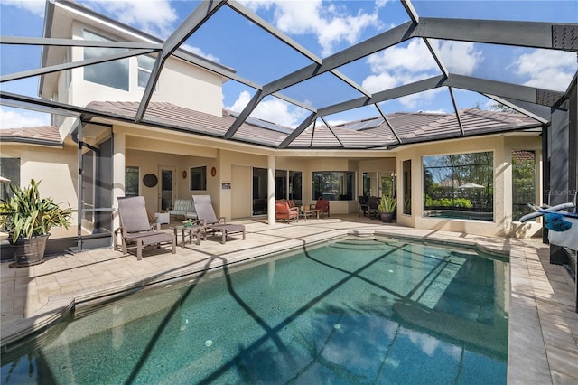 outdoor pool featuring a patio area and a lanai