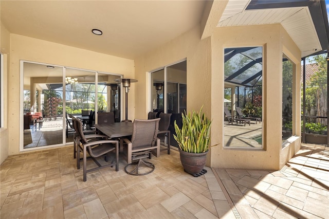 view of patio / terrace featuring a lanai and outdoor dining area