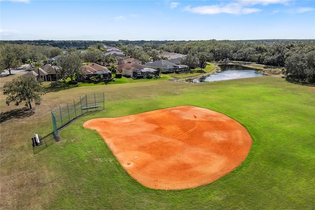 view of property's community with a water view, a residential view, and fence