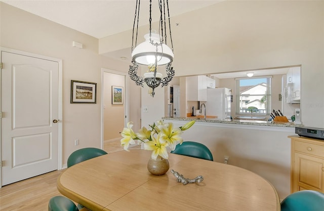 dining area featuring a chandelier and light hardwood / wood-style flooring