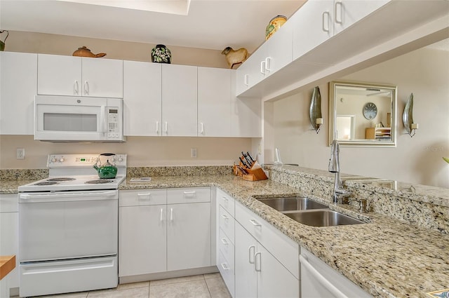 kitchen featuring sink, white appliances, and white cabinets