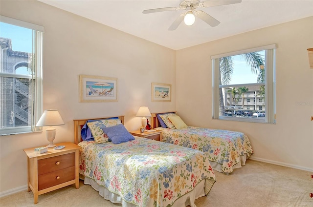 bedroom featuring ceiling fan and light carpet