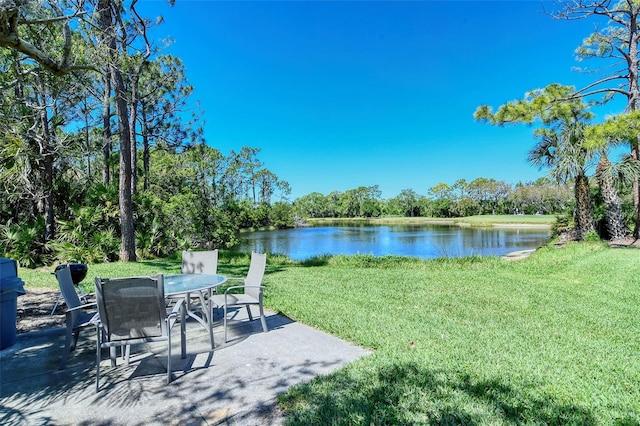 view of yard with a water view and a patio area