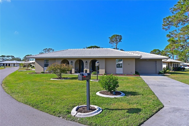 ranch-style house with a garage and a front lawn