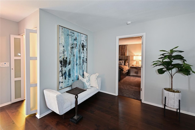 sitting room with dark wood-type flooring