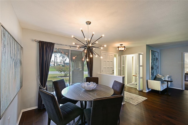 dining room featuring dark hardwood / wood-style flooring, a chandelier, and a textured ceiling