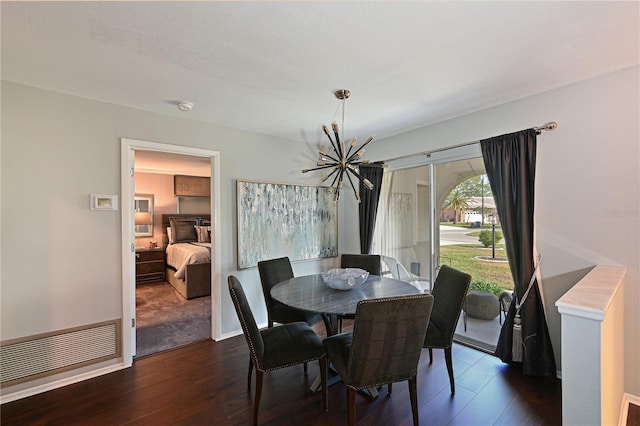 dining area with dark hardwood / wood-style flooring and a chandelier