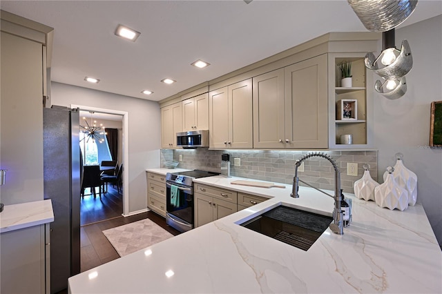 kitchen with decorative light fixtures, sink, light stone counters, stainless steel appliances, and dark wood-type flooring