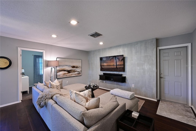 living room featuring a textured ceiling and dark hardwood / wood-style flooring