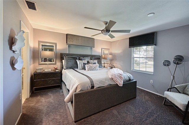 bedroom featuring ceiling fan and dark carpet