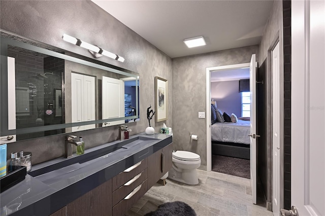 bathroom with vanity, an enclosed shower, and toilet