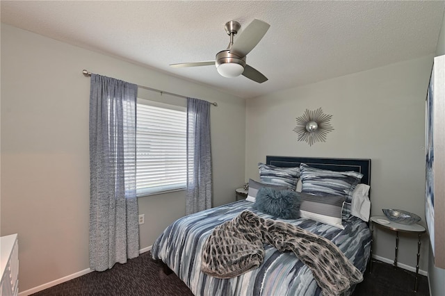 carpeted bedroom with ceiling fan and a textured ceiling