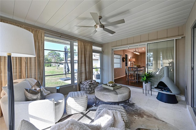 sunroom / solarium featuring wood ceiling and ceiling fan