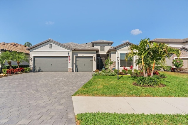 view of front of property featuring a garage and a front yard