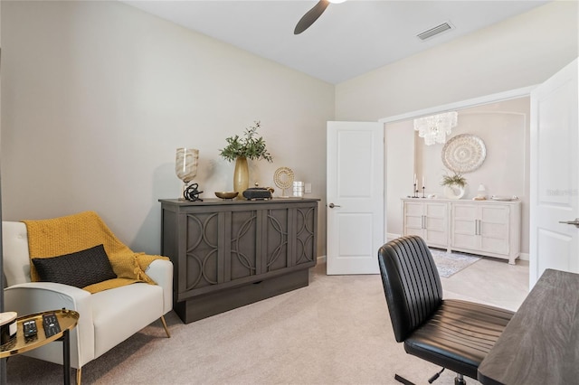 office featuring ceiling fan with notable chandelier and light carpet