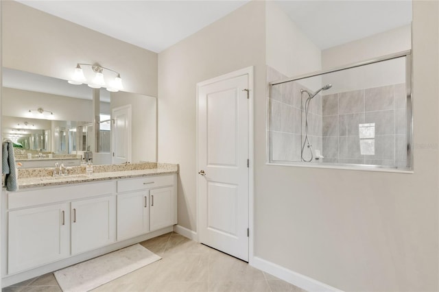 bathroom featuring vanity, tile patterned flooring, and a tile shower