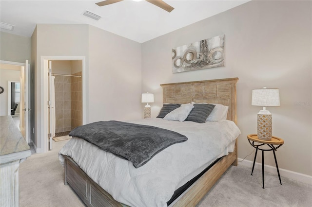 carpeted bedroom with ensuite bath and ceiling fan