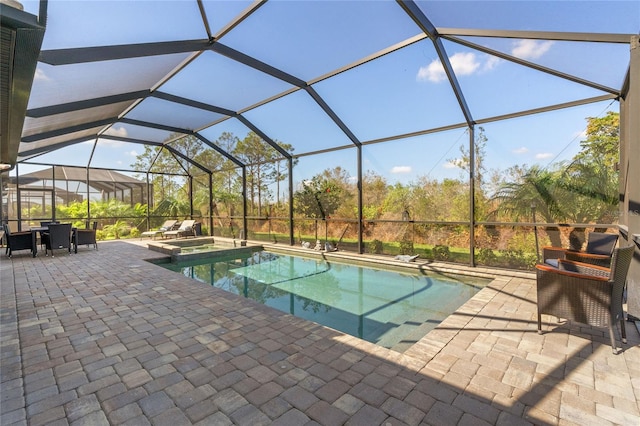 view of swimming pool featuring a lanai and a patio area