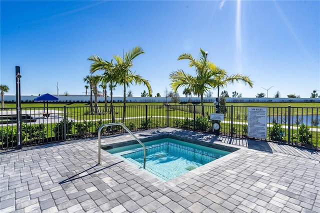 view of swimming pool featuring a hot tub