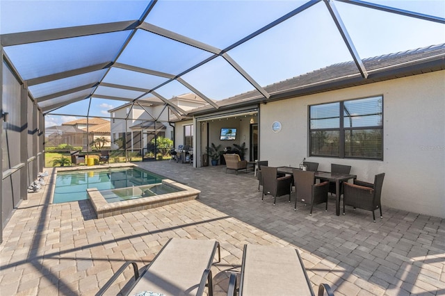 view of pool with an in ground hot tub, grilling area, glass enclosure, and a patio