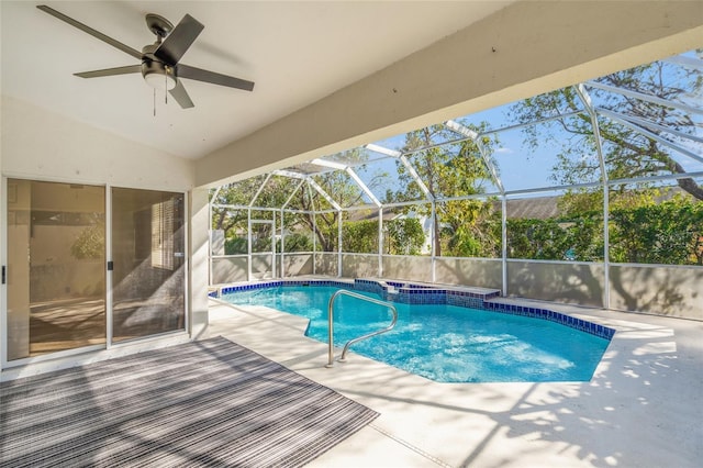 view of pool with a patio area and glass enclosure