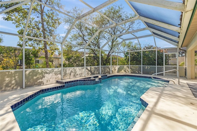 view of swimming pool featuring a lanai and a patio