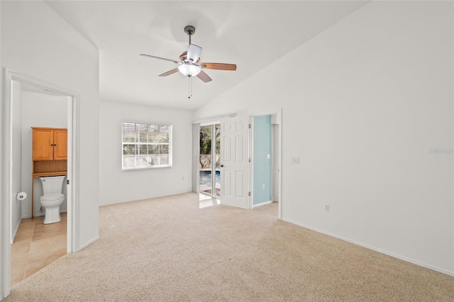 interior space with lofted ceiling, light colored carpet, and ceiling fan