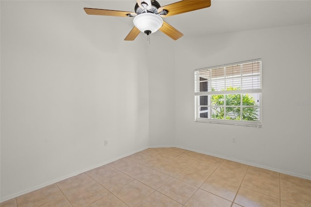 tiled spare room with ceiling fan