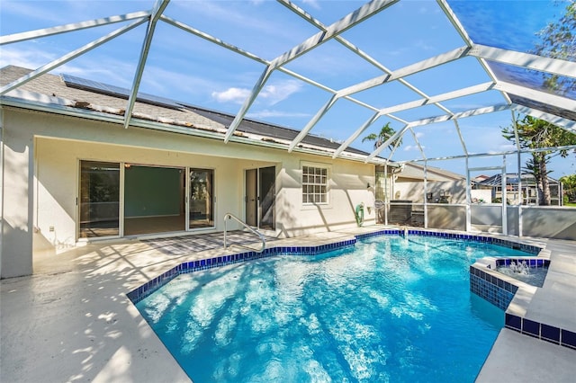 pool featuring glass enclosure and a patio area
