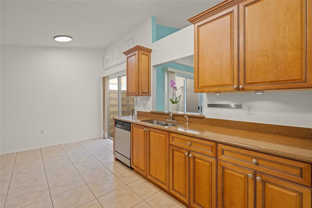 kitchen featuring dishwasher, baseboards, brown cabinets, a sink, and light tile patterned floors