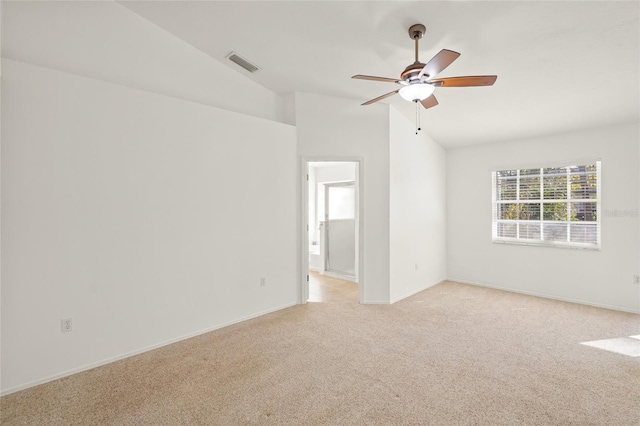 unfurnished room featuring visible vents, baseboards, a ceiling fan, lofted ceiling, and light colored carpet