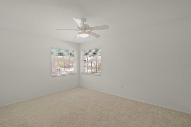 carpeted empty room featuring a ceiling fan