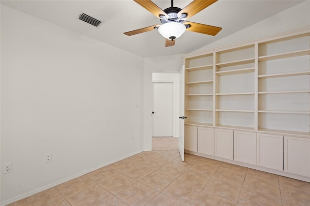 empty room featuring light tile patterned flooring, baseboards, ceiling fan, and visible vents