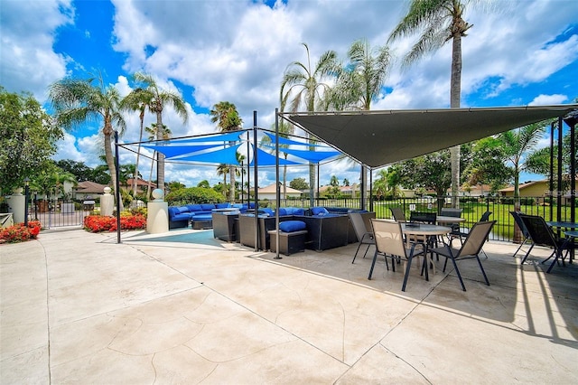 view of patio featuring outdoor lounge area and fence