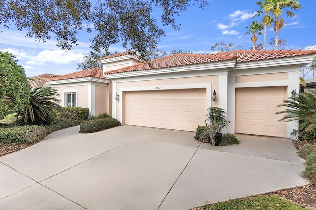 mediterranean / spanish house with a garage