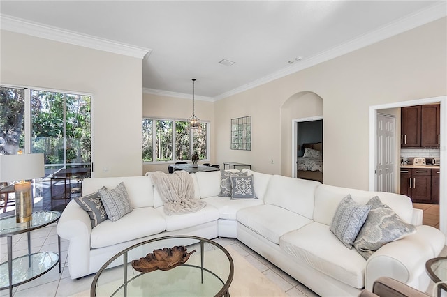 living room with light tile patterned flooring and ornamental molding