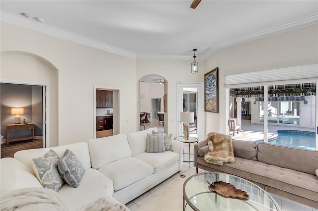 living room with ornamental molding and light tile patterned flooring