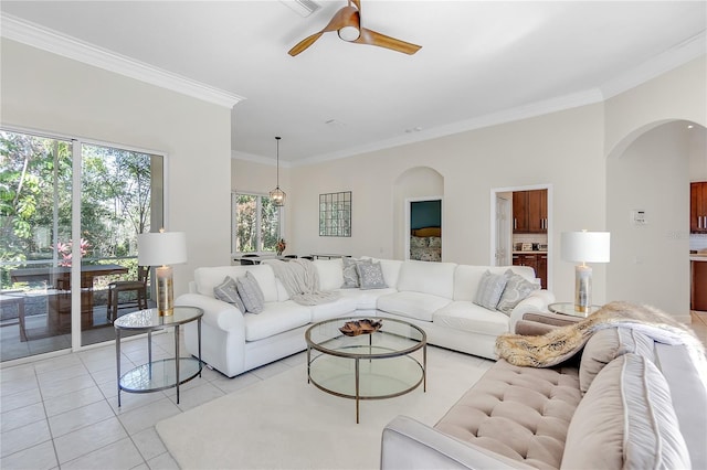 living room featuring light tile patterned floors, crown molding, and ceiling fan