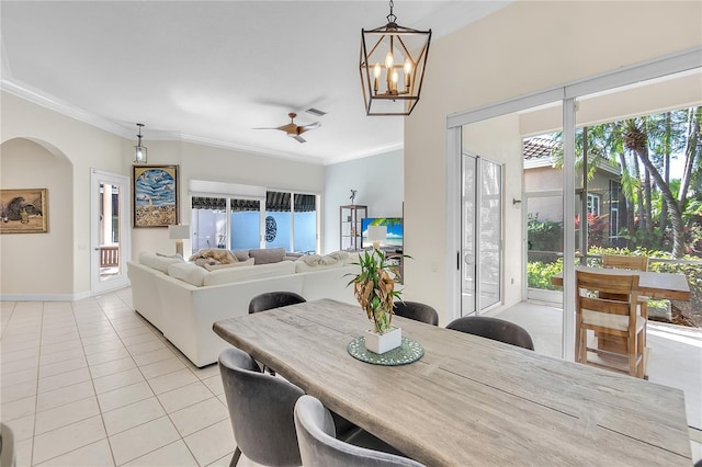 dining space with crown molding, ceiling fan, and light tile patterned floors