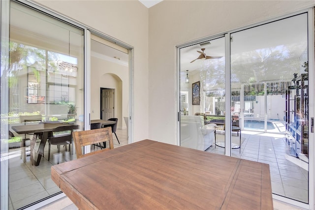 dining area featuring crown molding and light tile patterned flooring