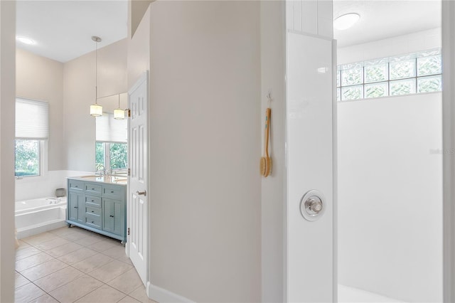 bathroom featuring tile patterned flooring, vanity, and a bathtub