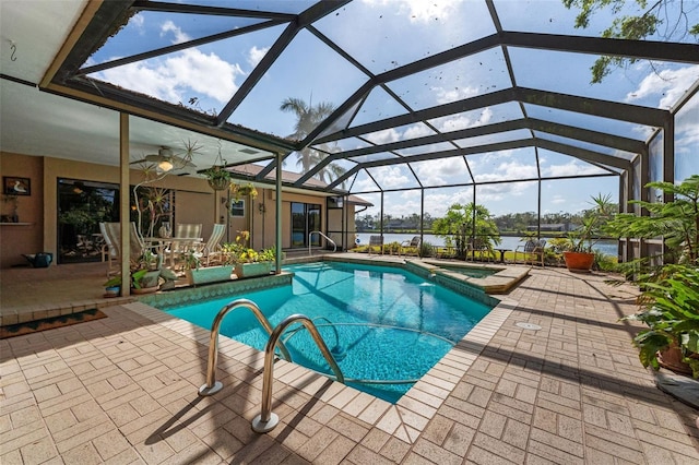 view of swimming pool with a lanai, a patio area, ceiling fan, and a water view