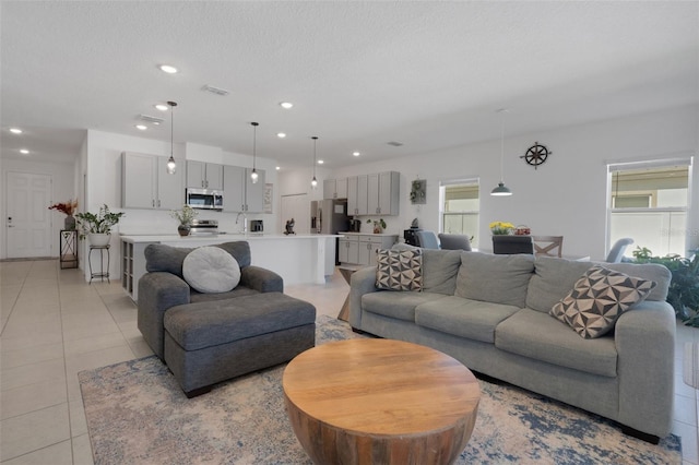 living room with light tile patterned floors and a textured ceiling