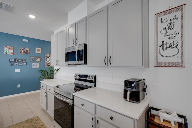 kitchen with light tile patterned flooring and stainless steel appliances