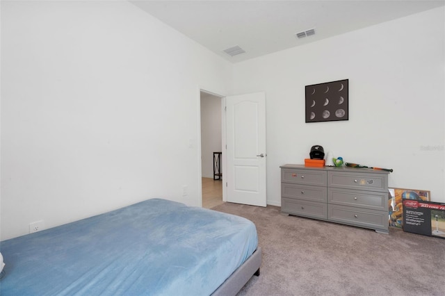 bedroom with light colored carpet