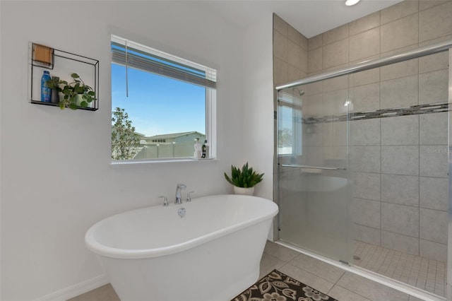 bathroom featuring tile patterned floors and separate shower and tub