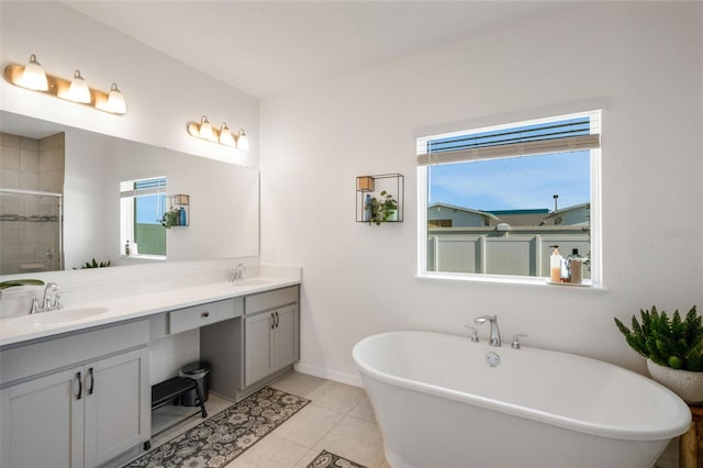 bathroom with tile patterned floors, shower with separate bathtub, and vanity