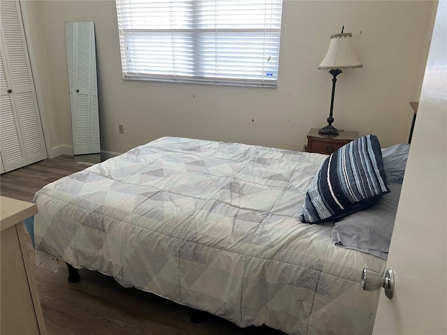 bedroom with dark wood-type flooring