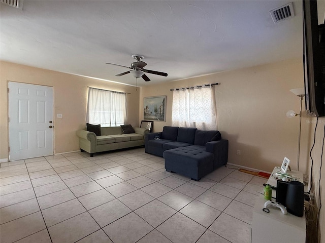 tiled living room featuring ceiling fan