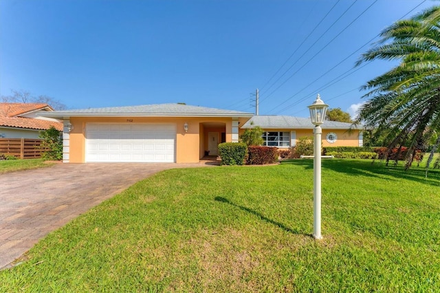 single story home with a garage and a front yard